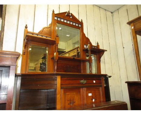 Late Victorian walnut chiffonier in Aesthetic style with a mirrored shelf back above a drawer, cupboards and open shelves 