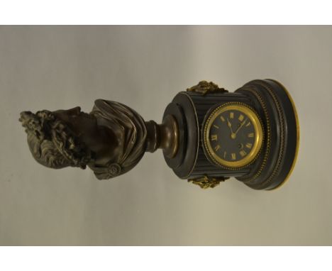 19th Century French black slate dark patinated and gilt bronze mounted mantel clock, the cylindrical case with mask head side