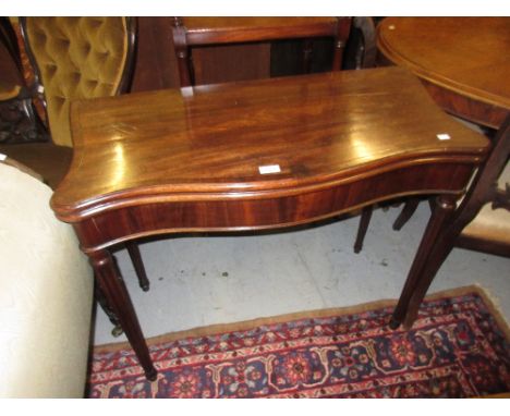 19th Century mahogany line inlaid serpentine fronted fold-over card table on turned tapering reeded supports, 29ins high x 36