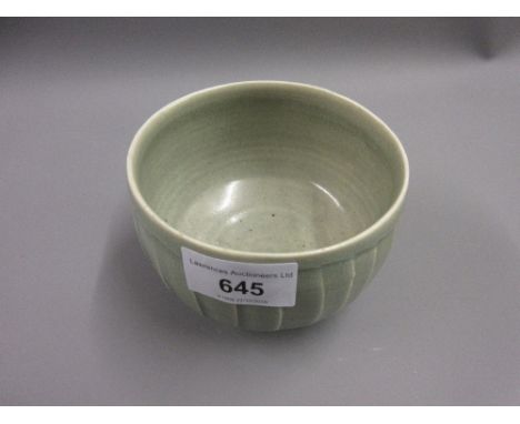 David Leach, a small stoneware bowl with incised decoration in a pale green crackle glaze on a low pedestal foot, 4.25ins dia