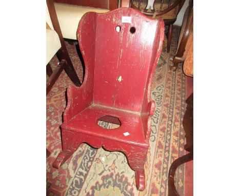 Antique red painted child's rocking / commode chair 