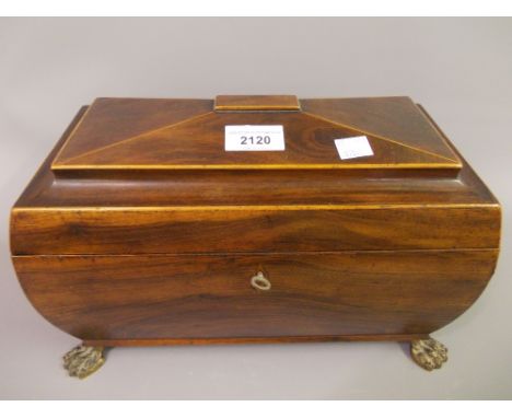 Early 19th Century mahogany boxwood line inlaid sarcophagus shaped tea caddy raised on gilt metal paw supports (later convert