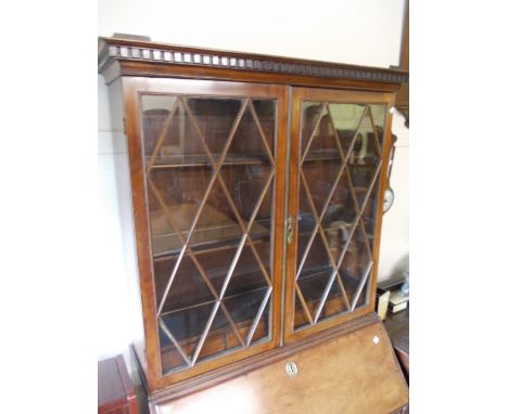 19th Century mahogany bureau bookcase having a moulded key pattern cornice above two astragal glazed doors enclosing adjustab