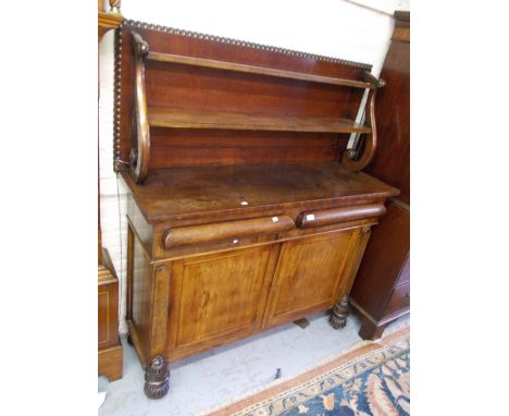 Late Regency mahogany chiffonier, the boarded shelf back with lyre shaped ends and a gadroon surround, the base with two draw