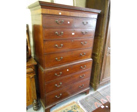 George III mahogany chest on chest, the moulded and inlaid cornice above two short and six long drawers with brass swan neck 
