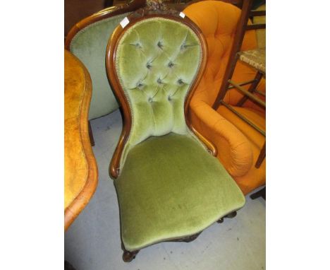 Victorian carved walnut and button upholstered open arm drawing room chair with floral surmount and cabriole supports, togeth