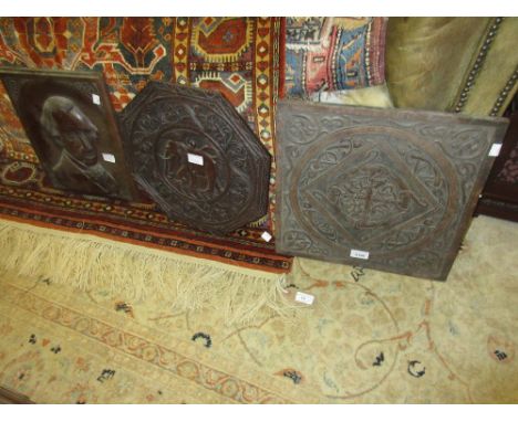 Square carved oak panel, a mahogany panel carved with a portrait and an Indian carved octagonal table top 