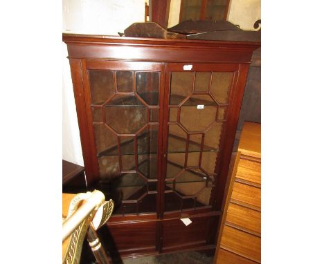 20th Century mahogany floor standing corner cabinet, having moulded cornice above two bar glazed doors with adjustable shelve