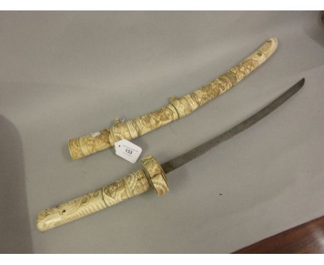 Japanese short sword with carved bone scabbard and grip 