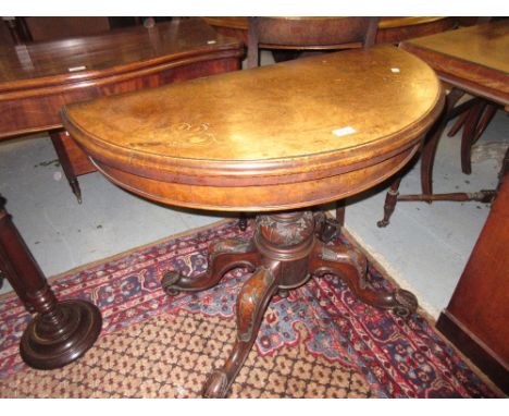 Victorian figured walnut marquetry inlaid demi lune card table raised on turned carved column and quadruped base 