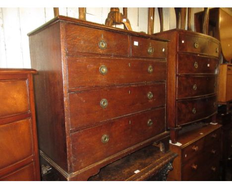 Late George III oak straight front chest of two short over three long drawers with brass ring handles raised on bracket feet,