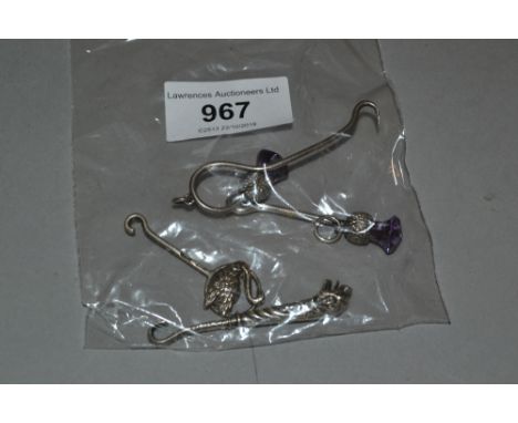 Four various miniature silver button hooks, two with thistle head surmounts 