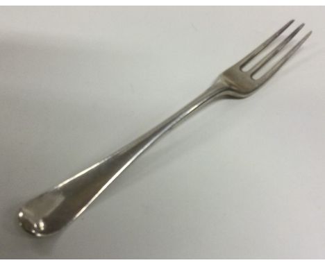 A Georgian silver three prong fork. Approx. 65 grams. Est. £40 - £60.