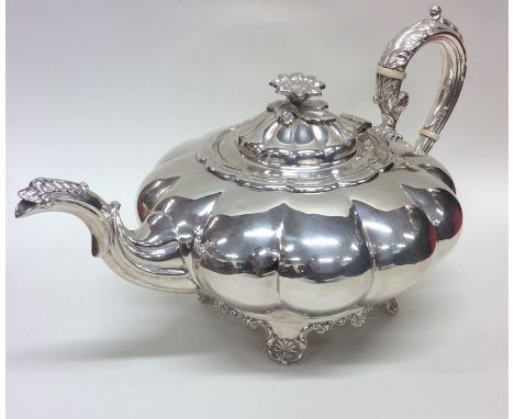 An extremely heavy and large good quality melon shaped teapot of Georgian style with floral finial to scroll handle. Birmingh