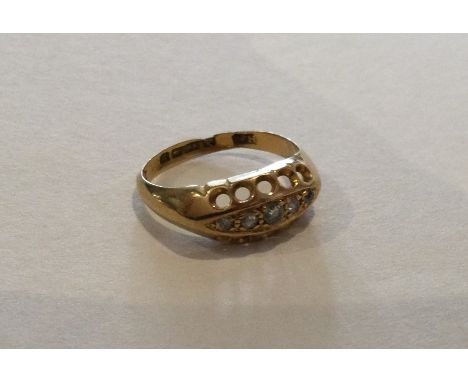 A diamond five stone boat shaped ring set in 18 carat gold. Approx. 2 grams. Est. £30 - £50.