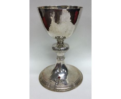 An unusual cased silver chalice together with matching patent decorated with knobbed stem to textured body and inset with rub