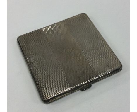 A heavy Art Deco silver compact of engine turned design. Birmingham. Approx. 90 grams. Est. £45 - £50.