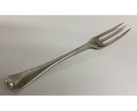 An early Georgian silver three prong fork with crested terminal. London. Approx. 34 grams. Est. £40 - £60.