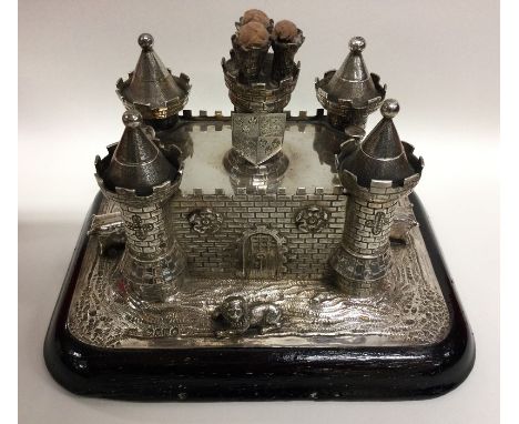 A rare and unusual Victorian novelty silver combination cigar lighter / cigar cutter in the form of a castle on rectangular s