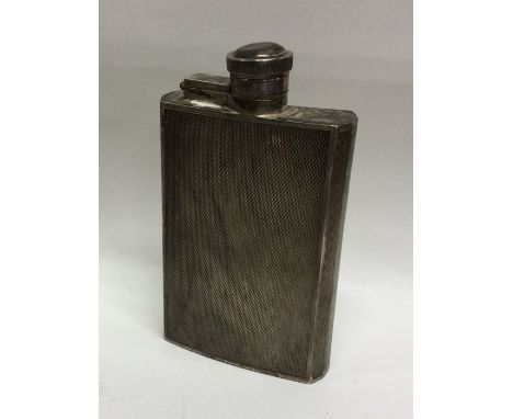 A heavy engine turned silver hip flask with lift-off cover. Sheffield. By JD&amp;S. Approx. 145 grams. Est. £60 - £80.