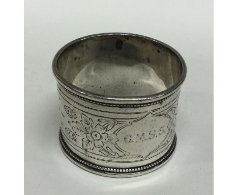 An Antique Russian silver napkin ring decorated with flowers. Approx. 40 grams. Est. £25 - £35.