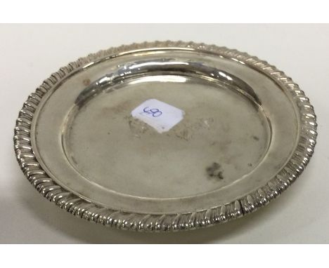 PAUL STORR: A circular silver teapot stand with gadroon rim. London. Approx. 14.5 cms in diameter. Approx. 241 grams. Est. £2