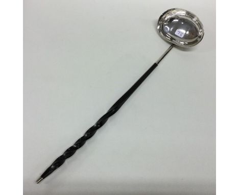 A Georgian silver toddy ladle with whalebone handle. London 1801. Approx. 44 grams. Est. £50 - £80.