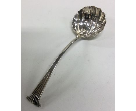 A heavy Onslow pattern silver sauce ladle with shell bowl. London. By TS. Approx. 46 grams. Est. £45 - £55.