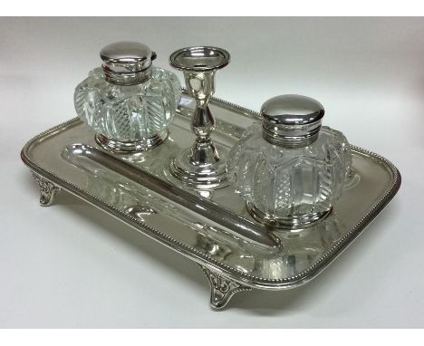 A Victorian silver inkwell with beaded rim to hinged tops on three spreading supports. Sheffield. By Martin Hall. Approx. 990