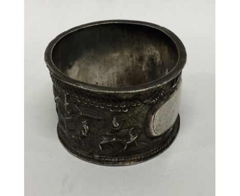 A Chinese silver napkin ring decorated with figures. Marked to interior. Approx. 38 grams. Est. £30 - £40.