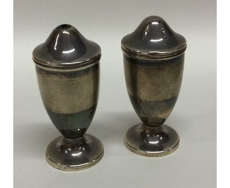 A pair of tapering silver engine turned cruets. Birmingham. Approx. 81 grams. Est. £25 - £35.
