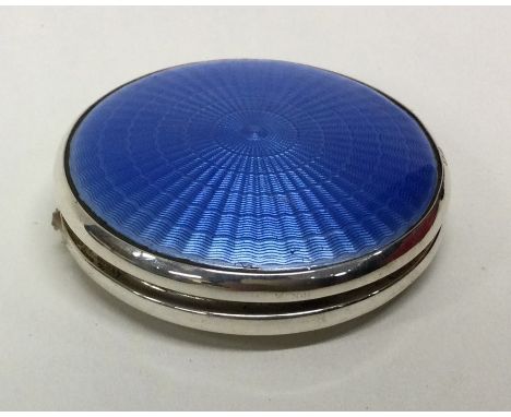 A silver and blue enamelled circular compact. Birmingham 1930. Approx. 60 grams. Est. £100 - £150.