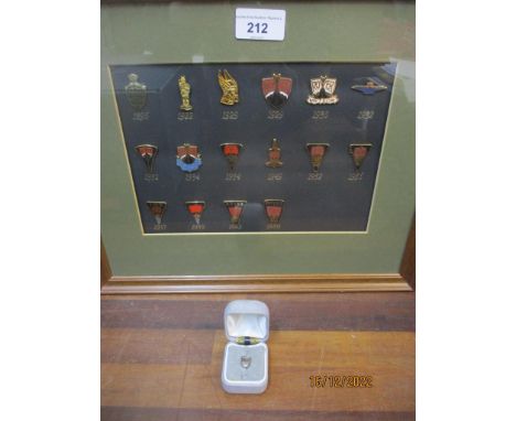 Framed and glazed collection of miniature Rover car badges and a boxed tie pin Location: 