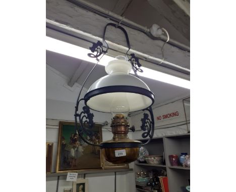 A vintage brass ceiling oil lamp with milk glass shadeLocation: RAB 