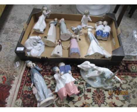 A group of Lladro and Nao porcelain figurines and animal groups to include a Nao figure of two choir boys, a Lladro polar bea