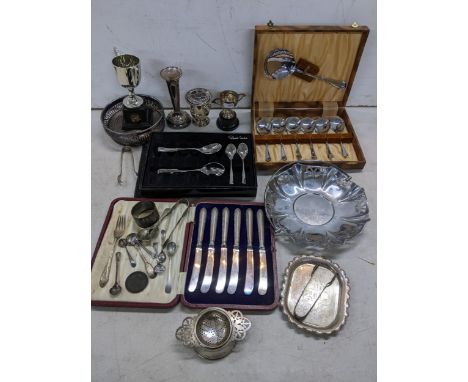 A mixed lot of silver and silver plate to include silver handled knives, silver napkin ring, a wine coaster and other items, 