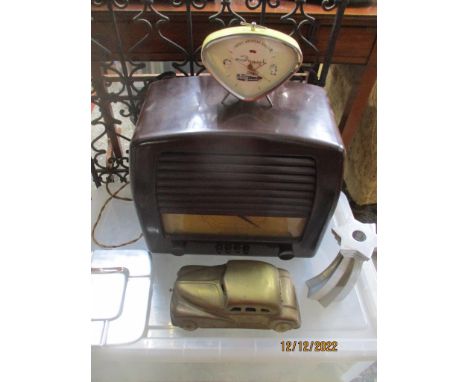 A General Electric Company (GEC) Bakelite cased radio, a Fossil American classic alarm clock, metal ashtray and candleholder 