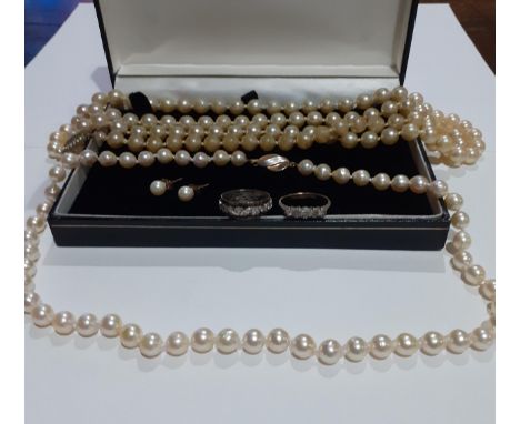 A sting of simulated pearls with a 9ct gold clasp and another string of simulated pearls together with a silver and white col