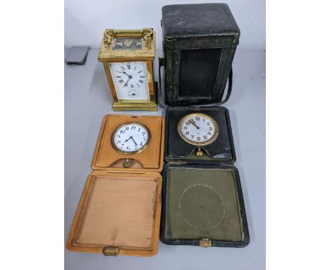 An early 20th century brass five window carriage clock with alarm, keys and fitted case and two travel clocks A/FLocation: 