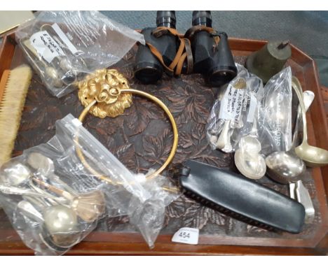 A mixed lot to include a carved tray, a vintage suitcase, mixed silver plate, binoculars, brushes, a brass door knocker, and 