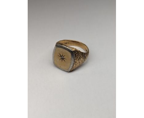 A 9ct gold and white metal signet ring of textured design, inset with central diamond, approx size Q 1/2, 10.2gLocation: 