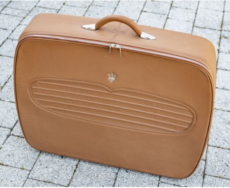 A Maserati suitcase,tan leather with stitched grille pattern and Maserati Trident badge to lid, zip opening to reveal Maserat