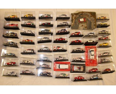 A collection of diecast rally cars and classic cars, mainly in original plastic boxes  