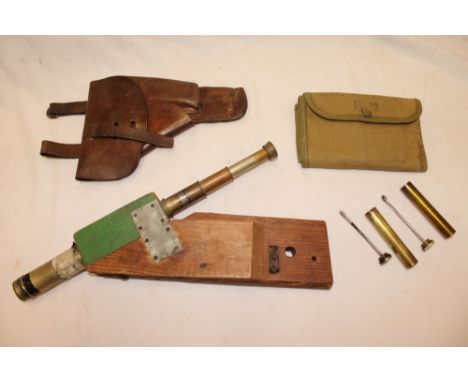 A hand made front line trench parapet telescope with wooden body, two various military .303 brass oil bottles, leather holste
