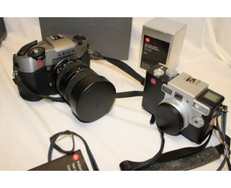 A Leica R9 camera with 1:4/35-70 lens, small Leica, Digilux 1 camera and a box containing various camera accessories etc
