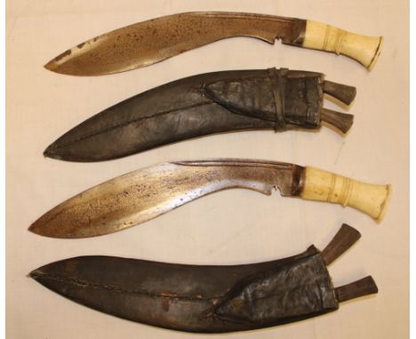 A pair of Nepalese Gurkha kukri with 12" curved single edged blades and bone hilts in leather sheaths 