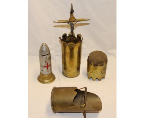 A selection of First War trench art including brass shell case crucifix constructed from bullets, trench art scuttle, brass s