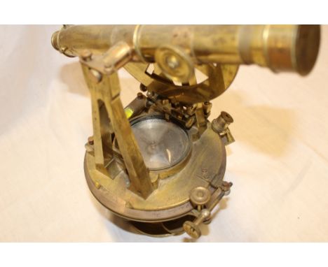 A good quality surveyor's theodolite/level by Suffett of London with silvered circular dial (minus glass) below sighting leve