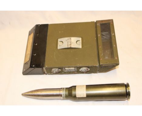 An inert 30m practice shell from a USA Fairchild A10 anti-tank jet aircraft used in the Gulf War and an American tank perisco