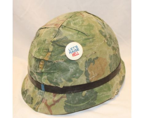 A United States Vietnam War era M1 helmet with camouflage reversible cover and liner  